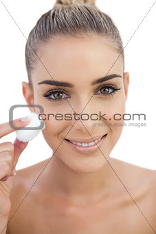 Smiling woman rubbing her face