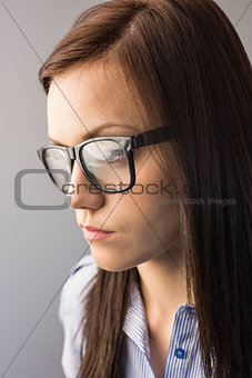 Day dreaming brunette with glasses posing