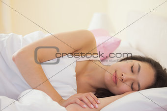 Young asian woman sleeping peacefully in her bed