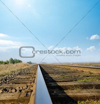railway to horizon under sunny sky