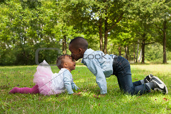 African boy is kissing his sister