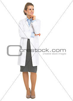 Full length portrait of thoughtful woman in white robe looking o