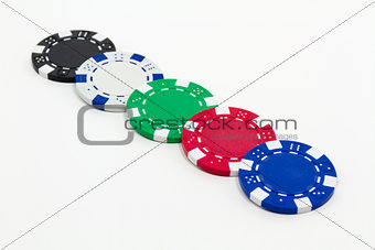 Row of poker chips isolated on white background