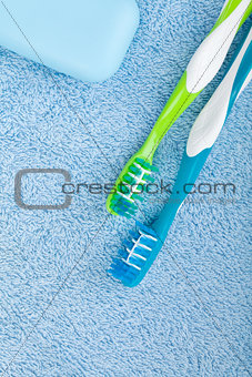 Toothbrushes and soap over towel