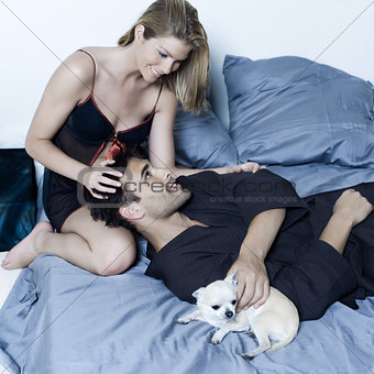 young couple in a bed strocking tenderness