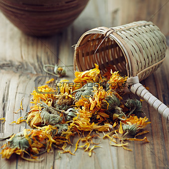 Dried Marigold Flowers with a bamboo tea strainer