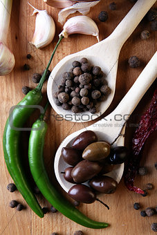 Olive and spices on wooden background