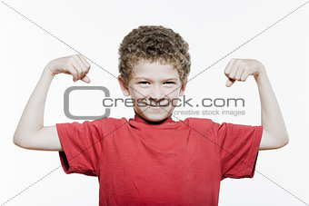 Little boy portrait strong flexing muscle biceps