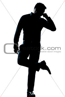 silhouette man full length looking at his shoes with unpleasant 