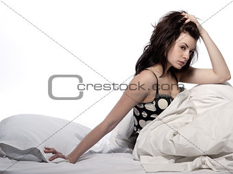 young woman in bed awakening tired insomnia hangover