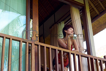 young woman drink coffee on balcony