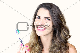 Beautiful young lady holding toothbrush and smiling