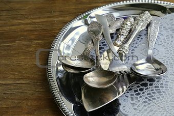vintage cutlery with old-fashioned napkin on a silver tray