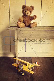 Antique toys on wooden bench with vintage look