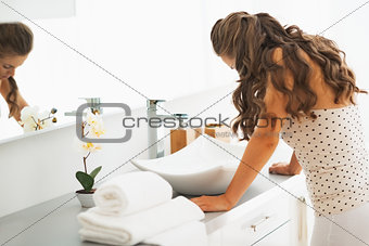 Stressed young woman in bathroom