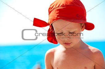 Thoughtful child on sea background
