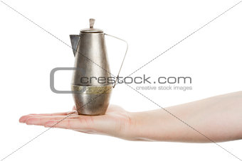 Hand holding silver jug