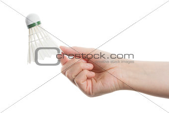 Hand holding white badminton shuttlecock