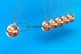 Newtons Cradle on a Blue Background