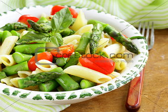 penne pasta with tomatoes and asparagus, fresh spring food