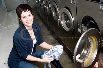 Laundry Day Pretty Brunette Woman Empties Dryer Laundromat