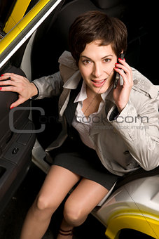 Business Woman Talking on Cell Phone Exits Taxi Cab