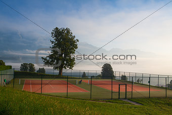 Tennis courts in the morning mist