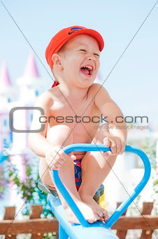 Happy child swinging on a swing