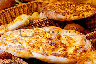 Bread cake lying on a basket with bread