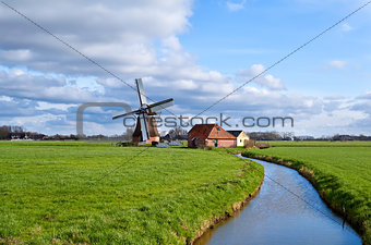 charming dutch windmill on green grasslands