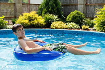 boy in the home swimming pool