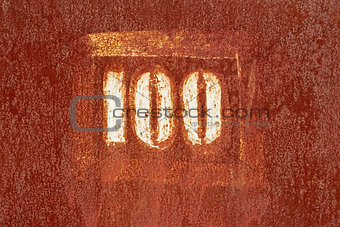 Number 100 painted on an old rusty surface