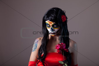 Portrait of sugar skull girl with red rose 