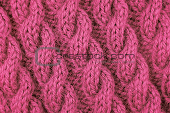 Closeup of pink cable stitch knitting