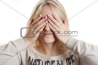 Girl covering her face by her hands