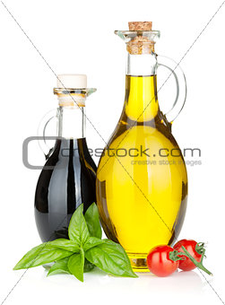 Olive oil, vinegar bottles with basil and tomatoes