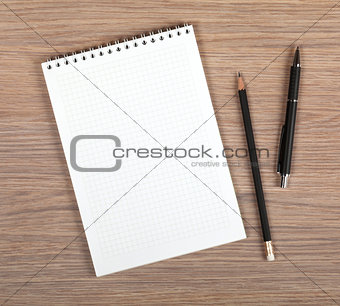 Blank notepad with pen and pencil