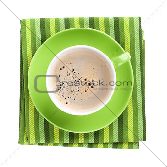 Green coffee cup over kitchen towel