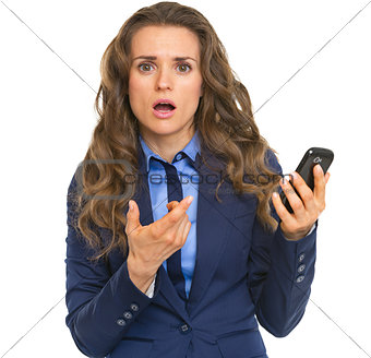 Frustrated business woman pointing on cell phone