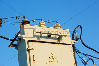 Old transformer against blue sky