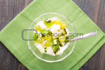 Glass bowl with ice cream and fruits