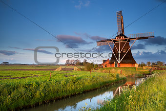 Dutch windmill in morning sunrise sunlight