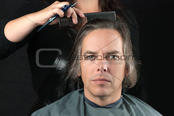 Man Getting Long Hair Combed In Preparation For Cut 