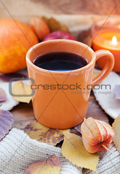 Orange coffee cup on the autumn fall leaves