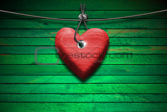 Red Wooden Heart on Green Wood Background