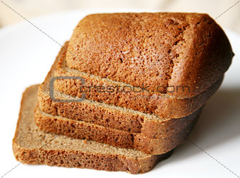 Borodino rye bread sliced on white plate