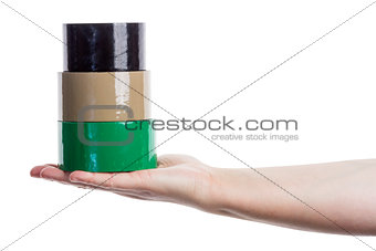 Hand holding tower made of adhesive tape