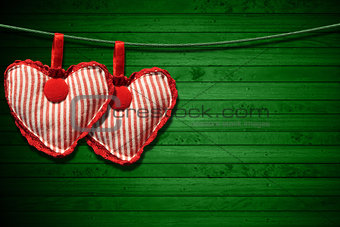 Red Cloth Hearts on Green Wood Background