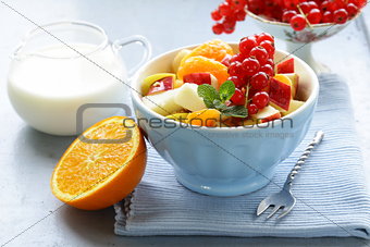 fruit salad with orange, apple and red currant