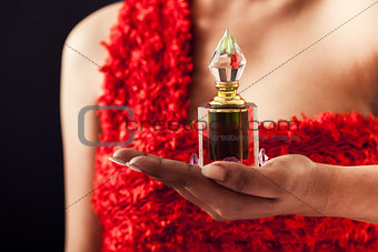 Female with bottle of perfume